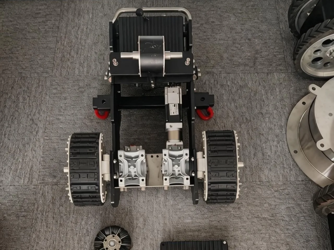 JT-1 wall-climbing robot chassis during assembly at Jingtao Energy factory — magnetic adhesion rubber wheel drive