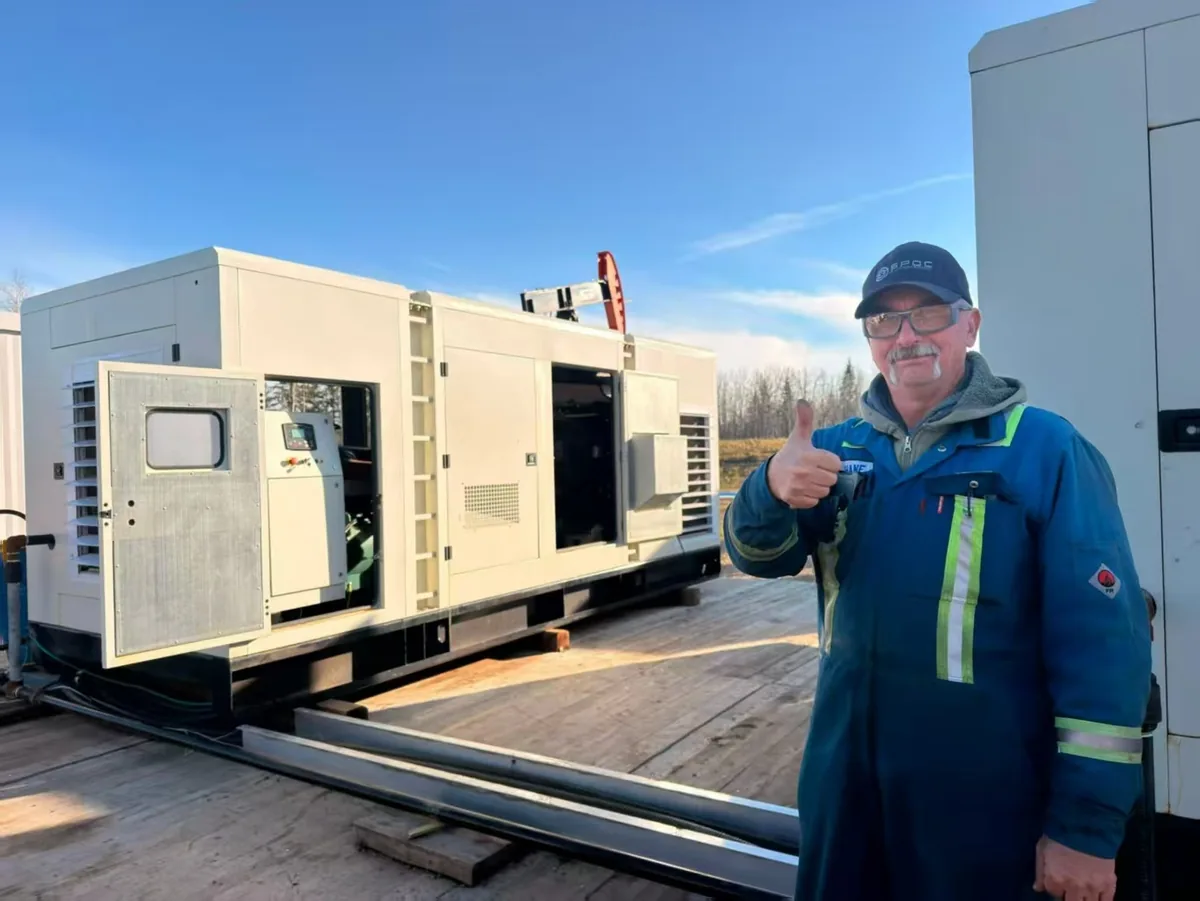 Four containerised units sit on a timber deck; a single controller handles start/stop, load switching and hour metering.