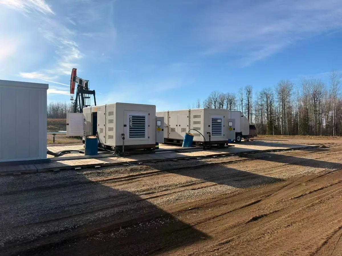 Gas generator sets beside a beam pumping unit at a remote off-grid oilfield